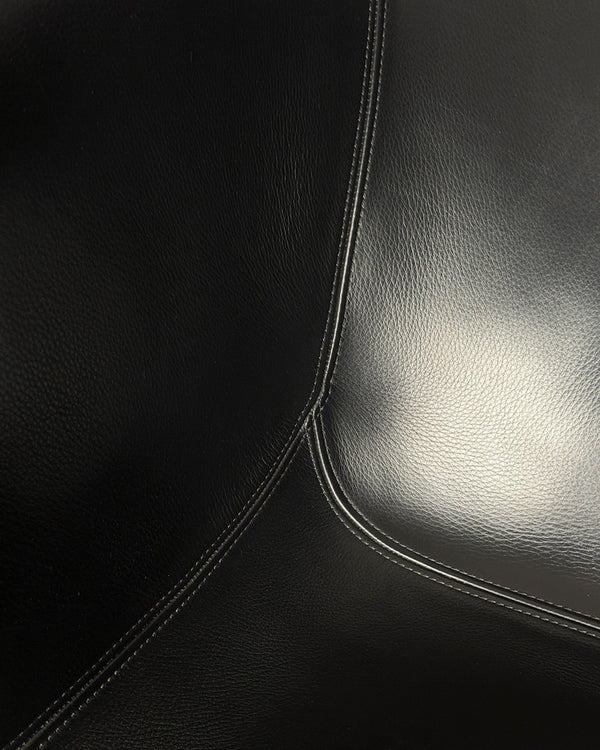 Close-up of black leather surface with stitching detail